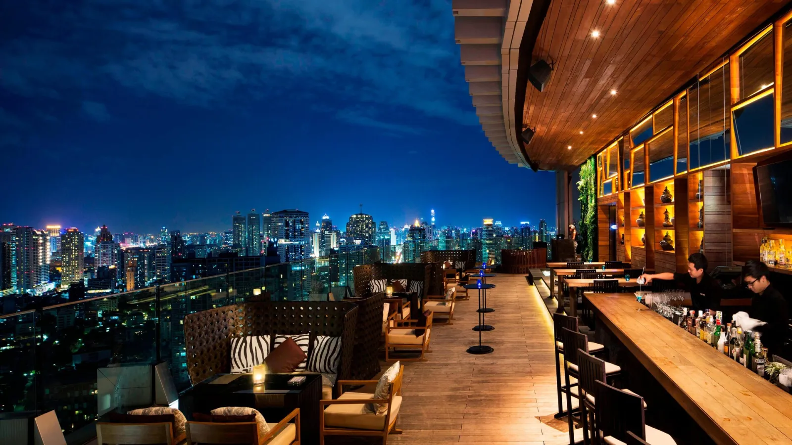 Octave rooftop terrace at night, with lounge seats and the lights of Bangkok below