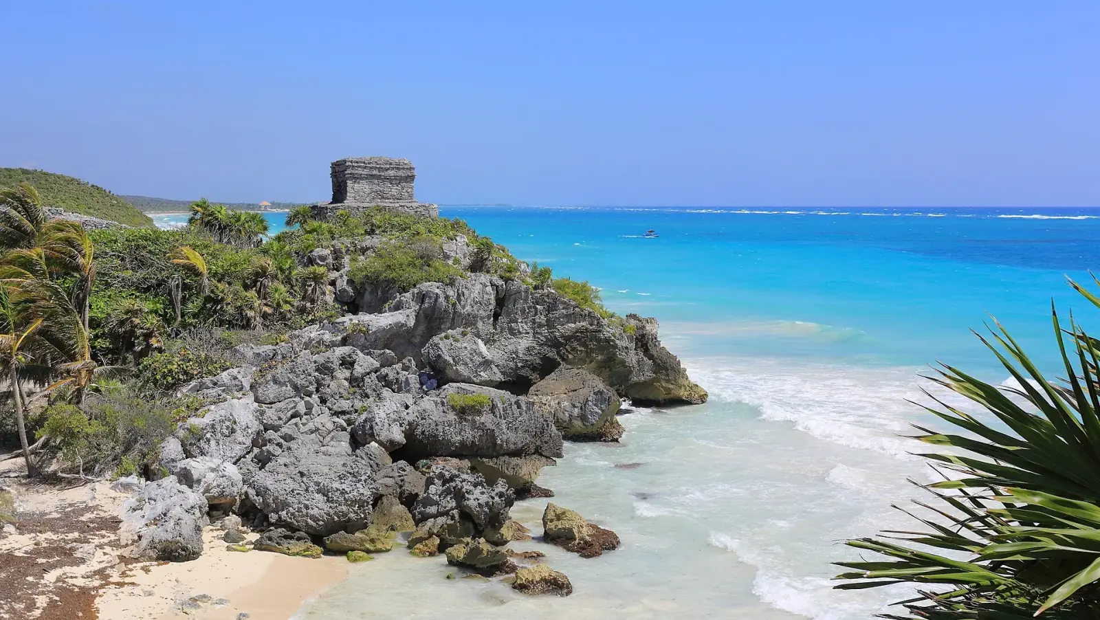 The Maya ruins of Tulum on a cliff above the turquoise Caribbean Sea