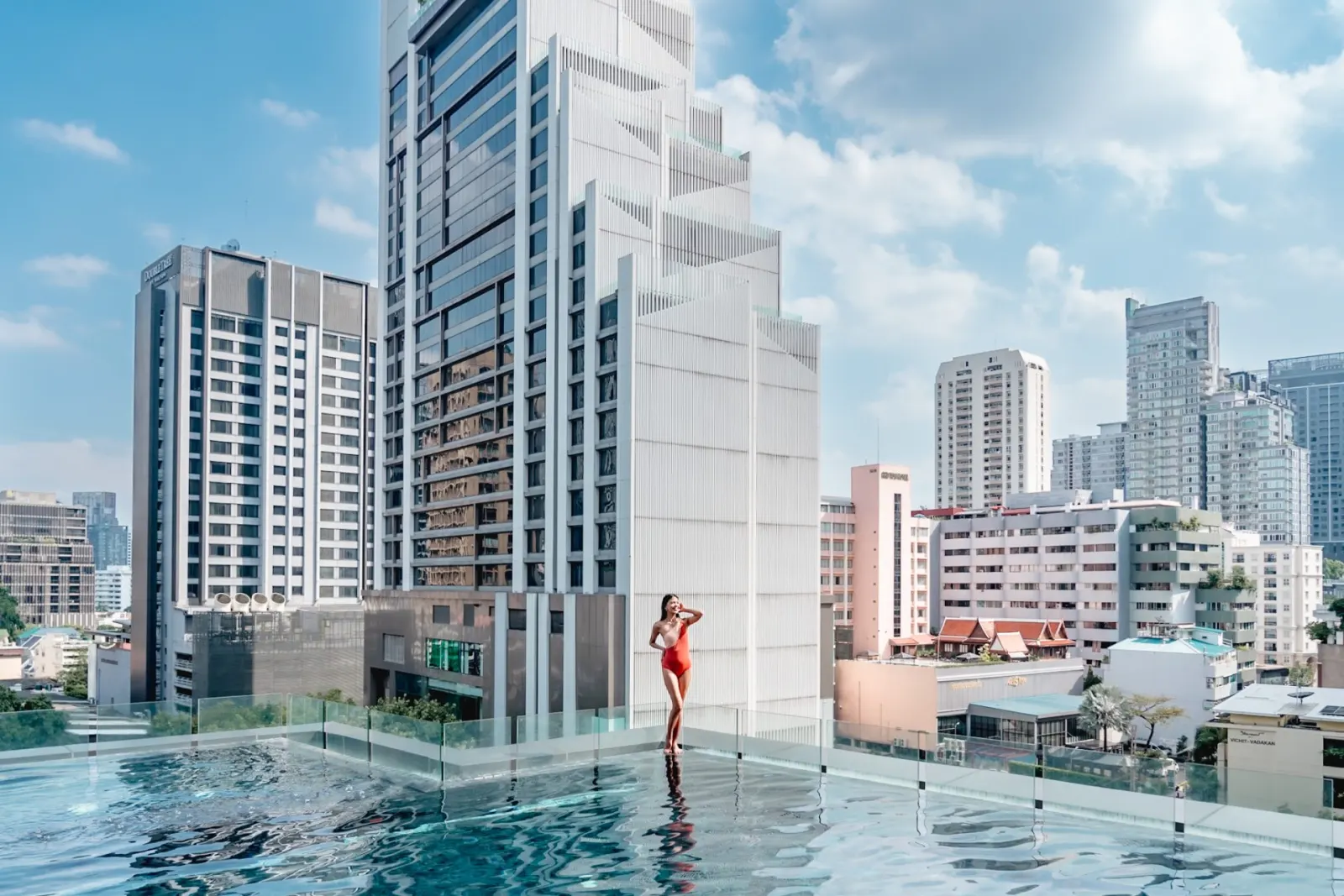 Glass-edge infinity pool between the Sukhumvit towers